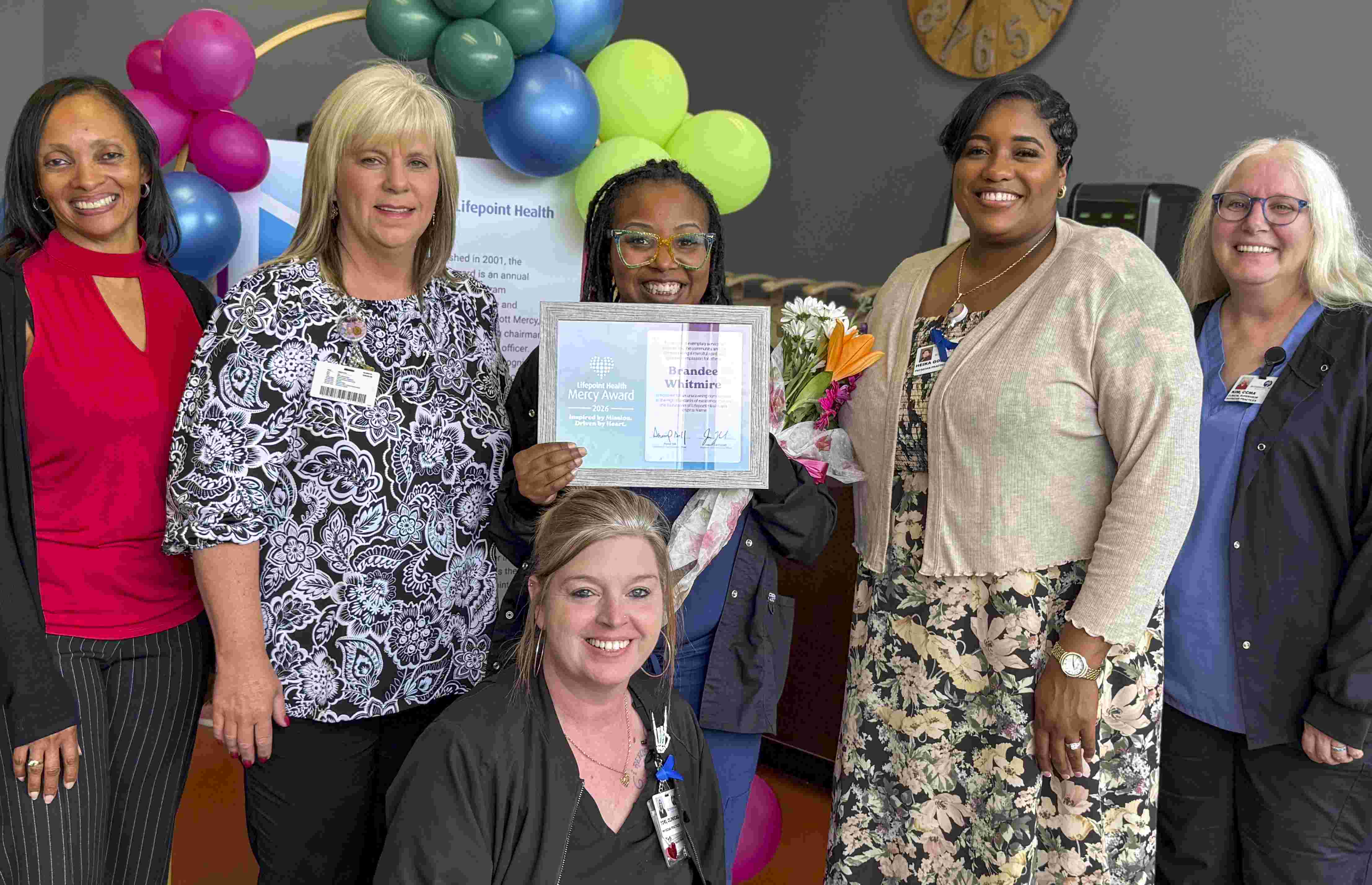 Brandee, 2026 Mercy Award Winner with her Team