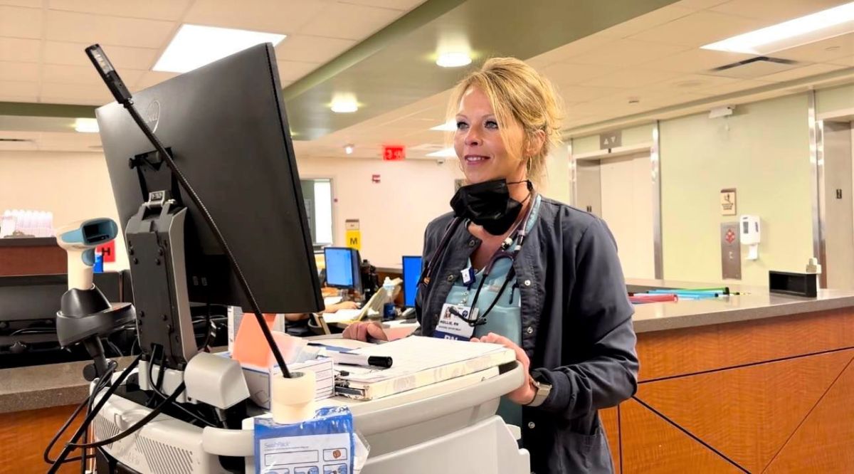Hollie Bell, RN, inputs patient information on a computer on 2nd Medical.
